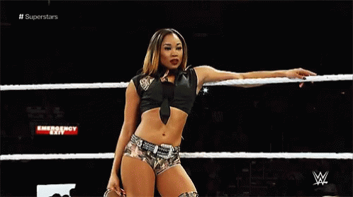 Female Wrestler Holding Rope in Wrestling Ring