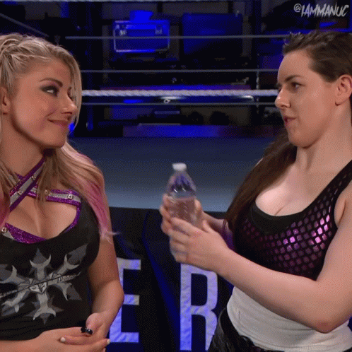 Female Wrestler Holding Water Bottle with Another Woman