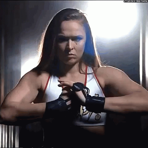 Female Wrestler in Dark Room with Boxing Gloves