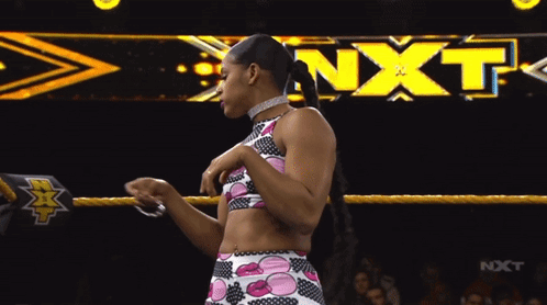 Female Wrestler in Front of NXT Banner