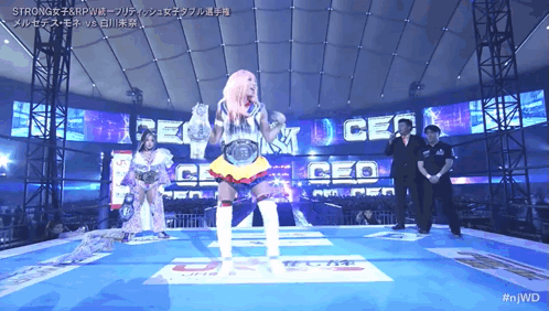 Female Wrestler in Front of Screen Saying Strong
