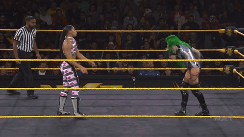 Female Wrestler With Green Hair Blowing Bubble Gum