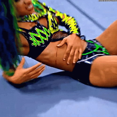 Female Wrestler With Green Hair Laying On Floor GIF