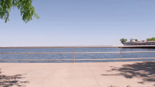 Fence Along Water With Building