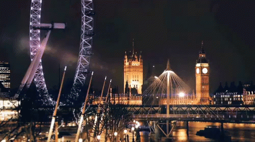 Ferris Wheel Lit Up at Night Near Big Ben