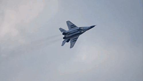 Fighter Jet Flying Through Clouds