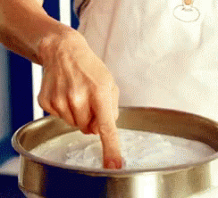 Finger Sticking Out Of Bowl Of White Liquid GIF