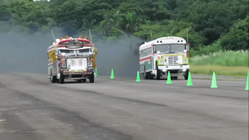 Fire Truck and School Bus Driving Past Green Cones