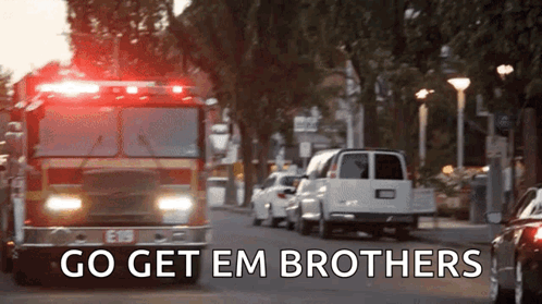 Fire Truck Driving Down Street Saying Go Get Em Brothers GIF