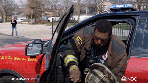 Firefighter Getting Out Of Chicago Fire Truck GIF