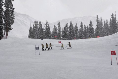 Firefighter Skiing While Holding On Fire Hose GIF