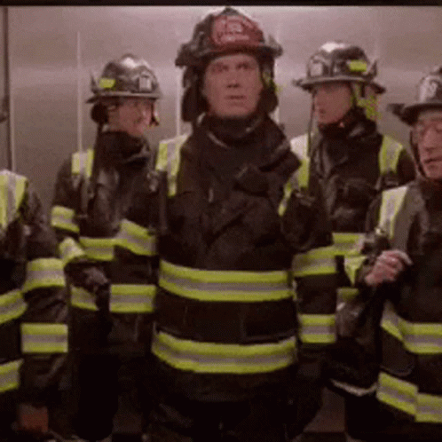 Firefighters Standing In Elevator With Helmets GIF