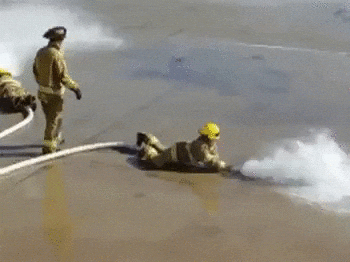 Fireman Bring Pushed Back By Fire Hose GIF