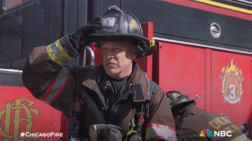 Fireman In Uniform In Front Of Chicago Fire Truck GIF