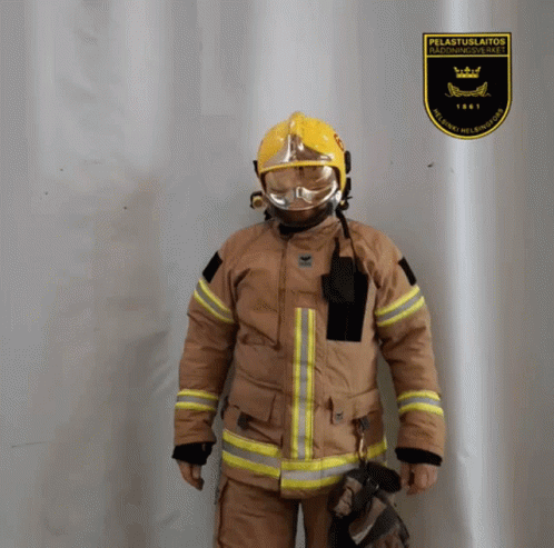 Fireman Standing In Front Of Pelastuslaitos Sign GIF