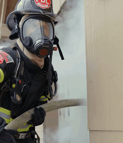 Fireman Wearing Mask And Helmet Saying UL GIF