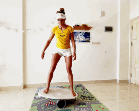 Fit Lady Paddle Boarding On Balance Beam GIF