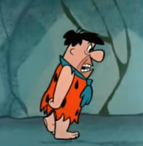 Flintstone Is A Cartoon Character From The Flintstones And Is Walking In A Cave . GIF