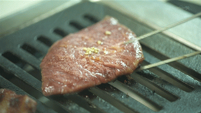 Flipping A Slice Of Quality Meat GIF
