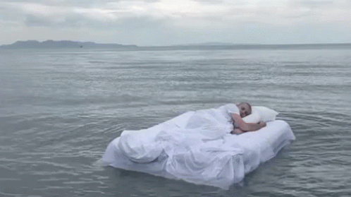 Sleeping Man Floating On The Ocean GIF