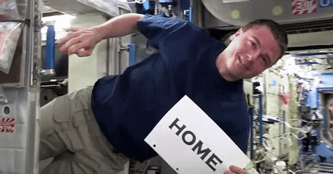 Floating Astronaut Holding Sign Home GIF