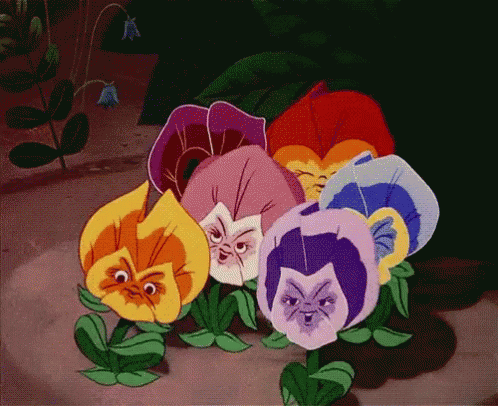 Flowers With Faces Sitting On Ground GIF