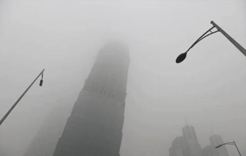 Foggy City With Very Tall Building