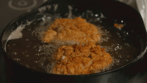 Food Being Cooked In Frying Pan With Bubbles