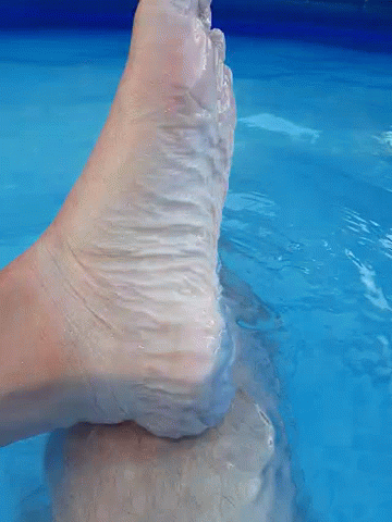 Foot Sticking Out of Blue Pool