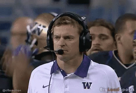 Football Coach in Headphones and Purple W Shirt