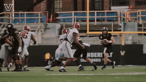 Football Game in Front of Sign Saying Ndert