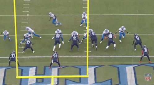 Football Game in Front of Titans Logo