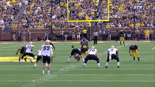 Football Game in Stadium With Michigan Banner