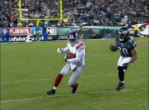Football Game Played In Front Of Playoff Sign GIF