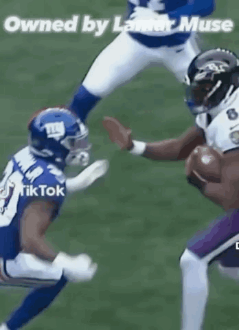 Football Player Being Tackled While Holding Ball