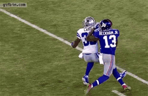 Football Player Catching Ball Blocked