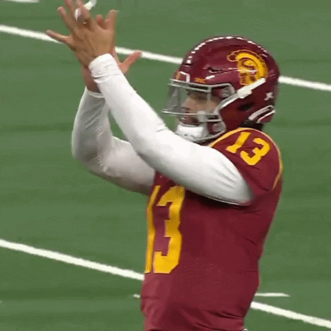 Football Player Clapping in Red Jersey and Helmet