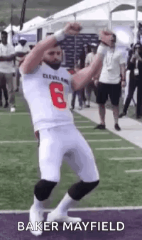 Football Player Dancing With Hands in Air