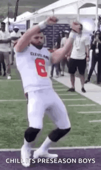 Football Player Dancing with Hands Up