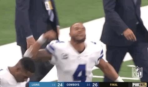 Football Player Helped Off Field by Coach