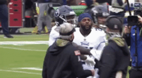 Football Player Helped Off Field By Nurse GIF