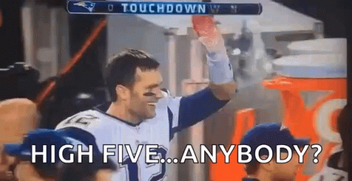 Football Player Holding Football High Fiving Crowd
