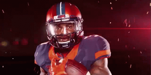 Football Player Holding Football