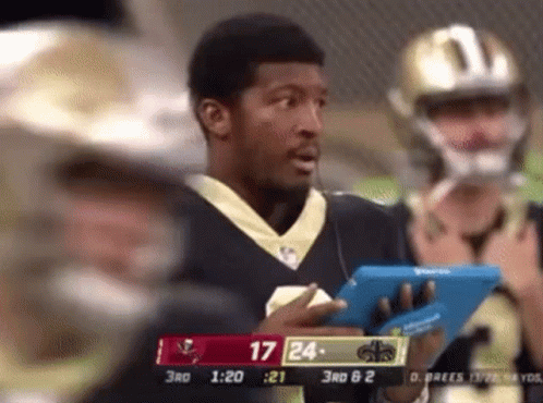Football Player Holding Tablet Watching Game