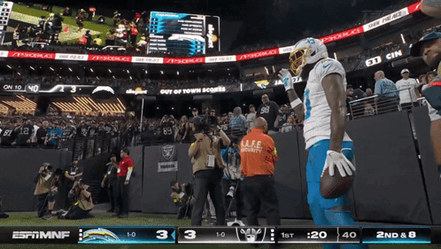 Football Player Holds Ball In Front Of ESPN MNF Screen GIF