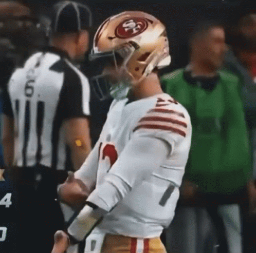 Football Player in 49ers Helmet Next to Referee