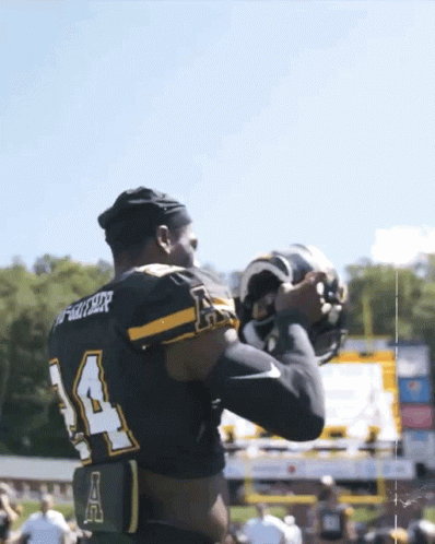 Football Player in Black Jersey Number 14