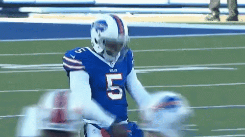 Football Player in Blue Jersey Running