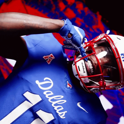 Football Player in Dallas Jersey and Red White Helmet