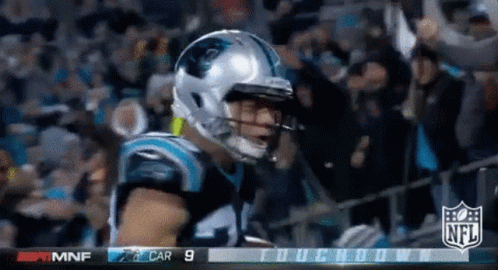 Football Player in Front of NFL Scoreboard